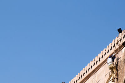 Low angle view of building against clear blue sky