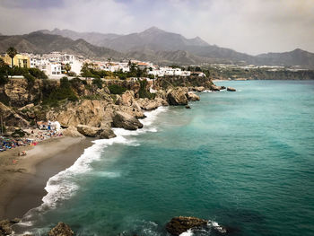 Scenic view of sea and mountains against sky