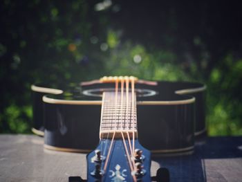 Close-up of guitar on table