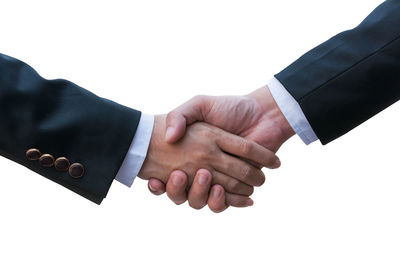 Cropped image of man holding hands against white background