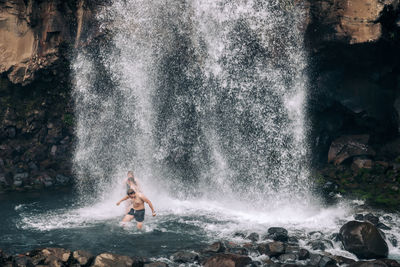 Man surfing on rock