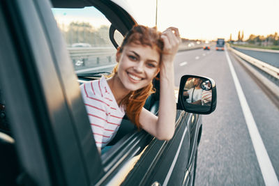 Portrait of smiling woman in car