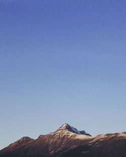 Scenic view of mountains against clear blue sky