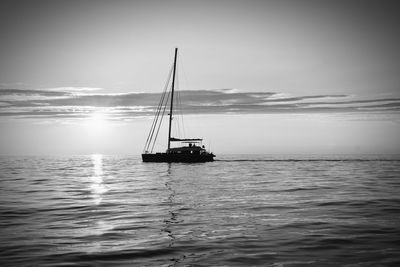 Sailboat sailing on sea against sky