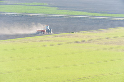 Tractor ploughing soil in a field