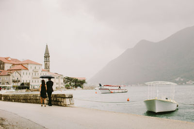 Full length of couple walking by river