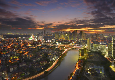 High angle view of illuminated buildings against sky at night