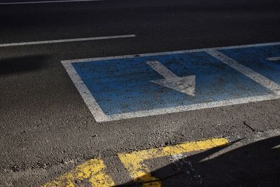 High angle view of arrow symbol on road