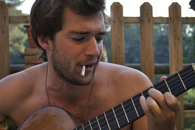 Portrait of man playing guitar