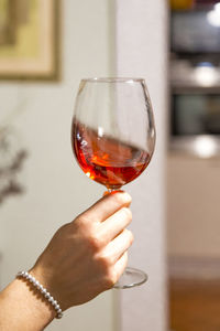 Female arm swirling a rose wine glass