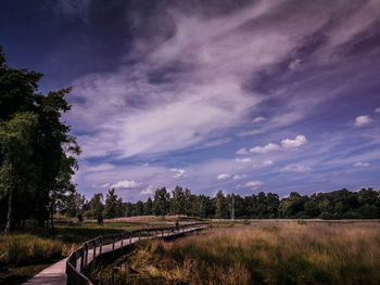 Road by landscape against sky