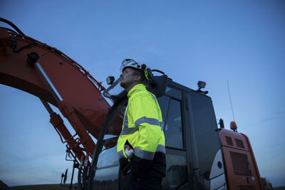 Worker in front of digger