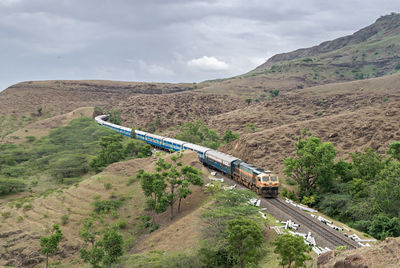 High angle view of road amidst mountains against sky