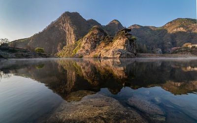 Scenic view of lake and mountains against sky