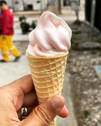 Close-up of hand holding ice cream cone