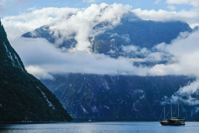 Scenic view of sea and mountains against sky