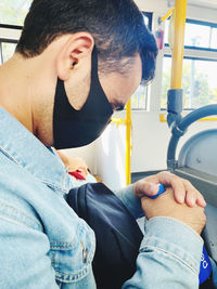 Midsection of man using mobile phone