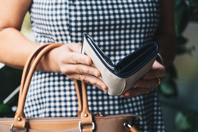 Midsection of woman with wallet