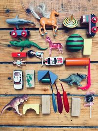 High angle view of various toys on wooden table