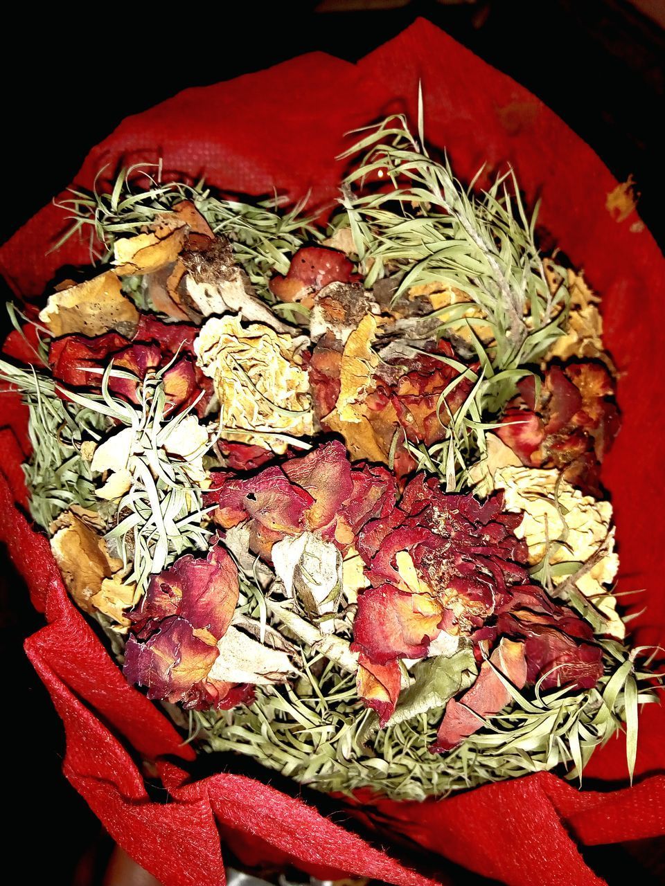 HIGH ANGLE VIEW OF RED CHILI AND FLOWERS ON FABRIC