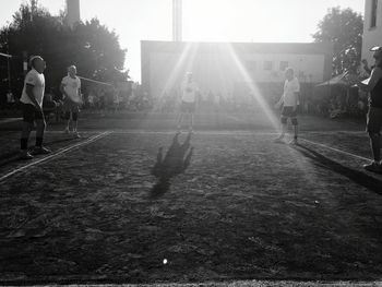 People playing in park on sunny day