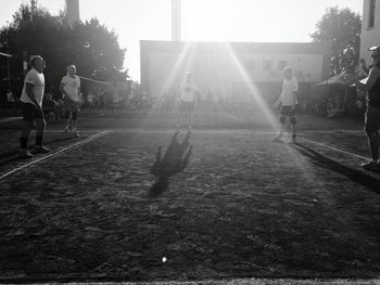 People playing in park on sunny day