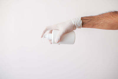 Close-up of hand holding white background