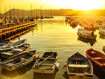 High angle view of boats moored at harbor during sunset