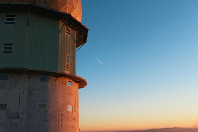 Low angle view of building against sky during sunset