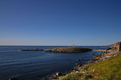 Scenic view of sea against clear blue sky