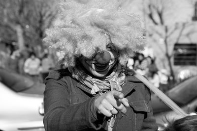 Smiling woman wearing clown costume standing outdoors