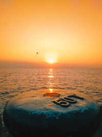 Scenic view of sea against orange sky