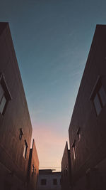 Low angle view of buildings against sky during sunset