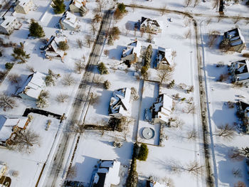 High angle view of snow covered trees by building