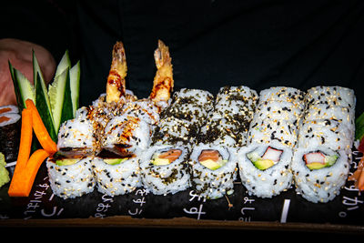 A selection of california sushi rolls served on top of a skateboard deck