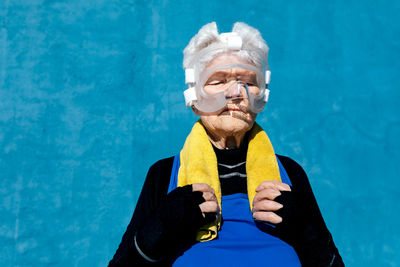 Portrait of man holding camera at swimming pool