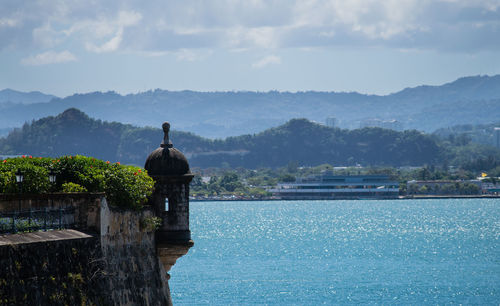 Scenic view of lake and buildings against sky