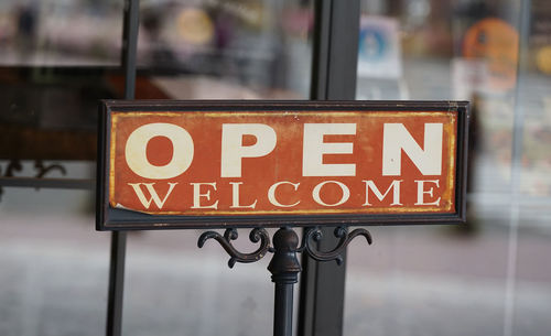 An open sign hanging on the storefront door