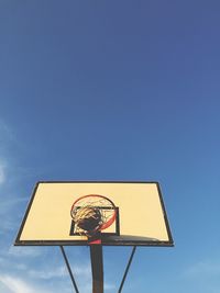 Low angle view of basketball hoop against blue sky