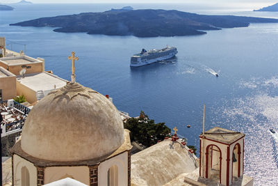 High angle view of building by sea against mountains