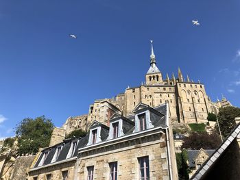 Low angle view of building against sky - mont saint michel france