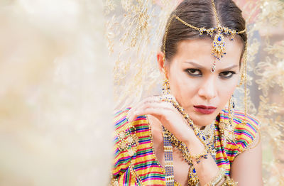 Portrait of woman wearing make-up and jewelry