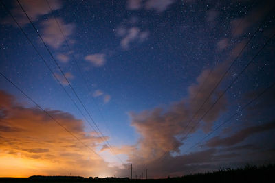 Low angle view of silhouette trees against sky at night