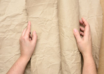 Cropped hand of man holding wrapping paper