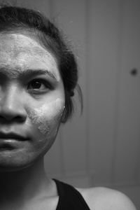 Close-up of young woman with facial mask