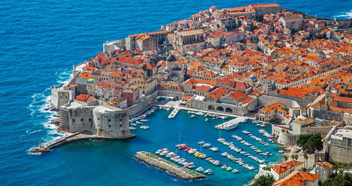 High angle view of townscape by sea