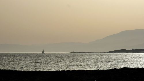 Scenic view of sea against clear sky during sunset