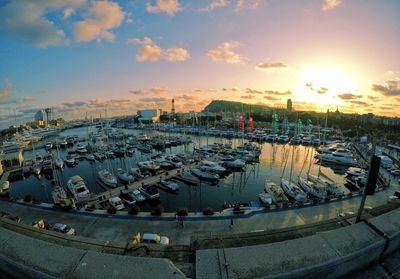 High angle view of boats moored at harbor against sky