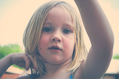 Close-up portrait of boy against sky