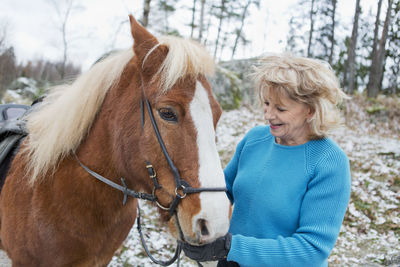 Senior woman with icelandic horse